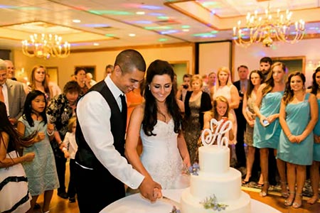 Shaefers banquet hall with bride and groom cutting cake.